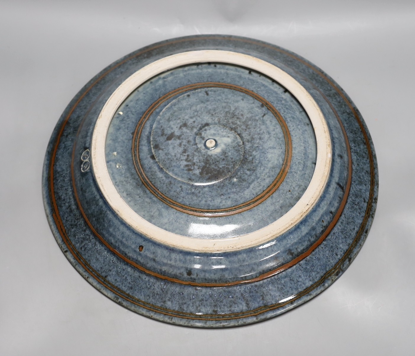 David Frith for Brookhouse Pottery - a circular stoneware charger with leaf and berry decoration. 41cm